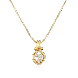 Macro view of a gold-plated heart pendant necklace featuring a heart-shaped cubic zirconia.