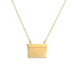 Detail of a vintage gold-toned envelope locket pendant on a delicate cable chain necklace