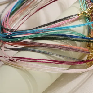 Close-up of colorful braided cord necklaces with gold clasps for DIY jewelry making.