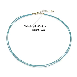 Close-up of turquoise three-layer braided cord necklace with gold extender chain