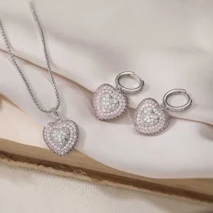 Close-up of elegant pink crystal double heart pendant necklace and earring jewelry set