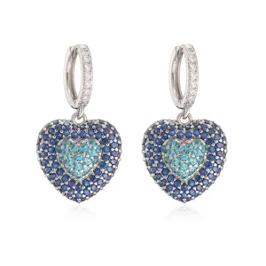 Detailed front view of silver-tone hoop earrings with blue pavé-set heart pendants