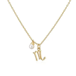 Detailed close-up showing the Scorpio zodiac symbol and pearl pendant on a gold chain necklace