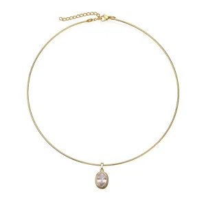 Close-up detail of a minimalist gold stainless steel choker with an oval zircon pendant.