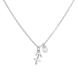 Close-up of silver Sagittarius zodiac sign pendant and small pearl on delicate chain