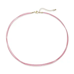 Macro detail of triple-layer pink woven cord choker with adjustable golden clasp.