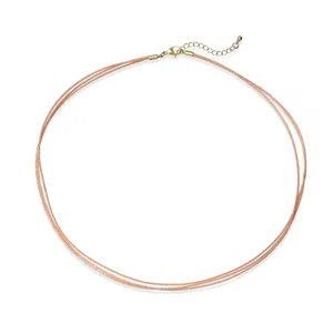 Detail of rose gold 3-layer braided cord choker necklace with adjustable gold clasp