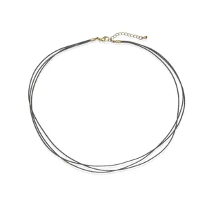 Close-up of triple-layer handmade black braided cord necklace with elegant gold clasp.