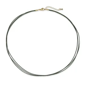 Detailed macro view of a minimalist three-strand green woven necklace with gold clasp