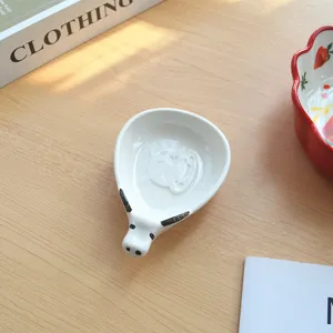Detailed view of a cute ceramic animal shaped sauce dish, Japanese style cartoon design.