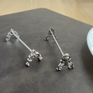 Close-up of vintage carved silver stainless steel knife and fork rests on dark leather mat.