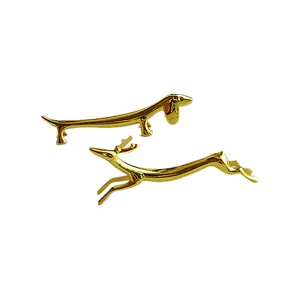 Detailed view of polished golden metal chopstick rests in cute dachshund and deer animal shapes