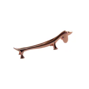 Rose gold dachshund shaped metal chopstick rest with smooth polished finish