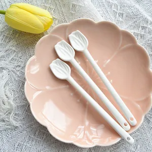 Vue détaillée de trois cuillères à café en céramique blanche en forme de tulipe