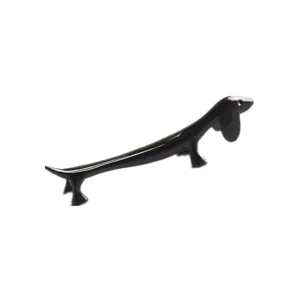 Close-up of a sleek black dachshund-shaped chopstick rest on a white background
