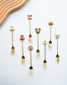 Cute stainless steel fruit forks set with sweet cartoon charms, perfect for cakes and desserts.