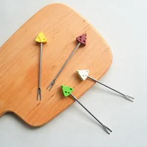 Detailed view of cute cheese-shaped fruit forks with stainless steel prongs and colorful handles.
