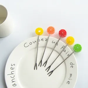Cute stainless steel fruit forks set with colorful fruit slice handles for dessert restaurant.
