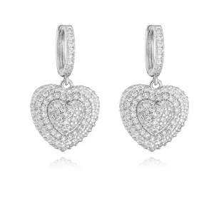 Close-up of sparkling silver heart earrings with double-layered CZ pavé stones