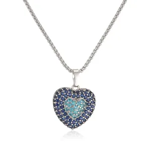 Detailed shot of a double-layered heart pendant necklace with shimmering blue stones