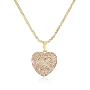 Detailed macro view of a luxury gold heart necklace featuring pink and white gemstones