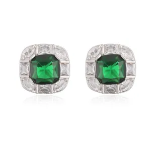 Macro view of elegant square stud earrings with green emerald and clear crystals