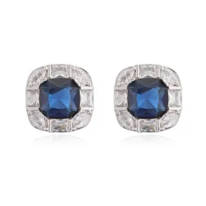 Macro view of luxurious square stud earrings with a blue gem and white diamond halo