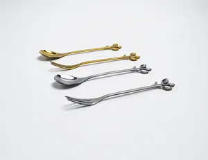 Detailed macro view showing creative leaf-shaped handle design on stainless steel spoons