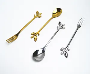 Detailed view of elegant gold and silver leaf-shaped stainless steel spoons and forks