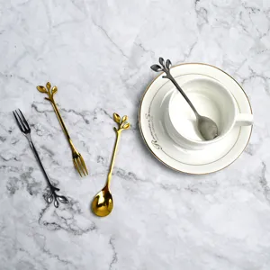 Detail of elegant leaf handle design on gold and silver stainless steel spoons and forks
