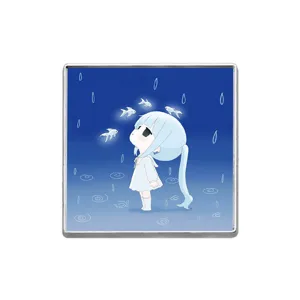 Square metal brooch pin featuring an aesthetic anime girl looking at glowing fish