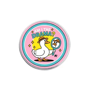 Funny circular cartoon duck enamel pin badge with Am I The Drama text on white background