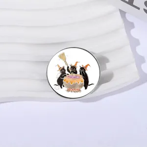 Round Halloween metal pin badge with three black cats brewing a magical potion.