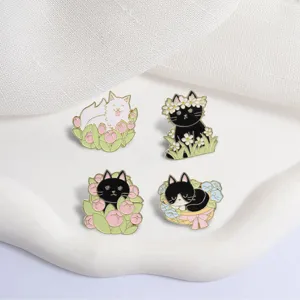 Detailed close-up view of four different spring cat enamel pins with floral designs.