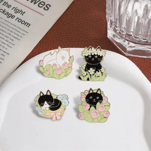 Close-up of cute cartoon cat enamel pins with floral tulips and daisies art design