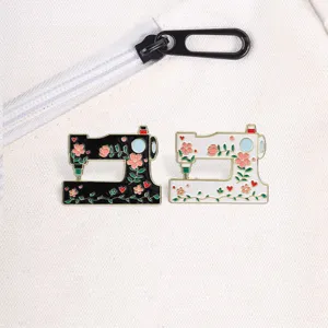 Detailed view of vintage floral sewing machine enamel pins on white canvas bag.