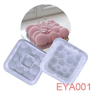 Silicone bubble cake mold detail view, showing transparent square baking tray and finished pink mousse.