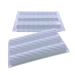 Close-up detail of a white triple-cavity silicone mousse mold featuring a twist rope design