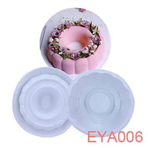 Detail shot of white silicone mousse cake baking mold with finished flower decorated cake effect.