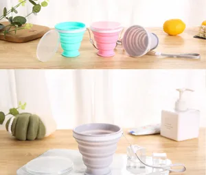 Collapsible silicone travel cup with lid and lanyard shown in home setting context
