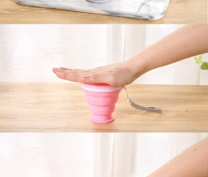 Action shot showing the collapsible silicone cup being pressed flat