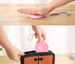 Pink silicone collapsible cup being folded and stored in a small bag for easy travel portabilty