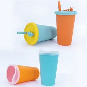 Detail view of colorful silicone baby sippy cups with lids and straws