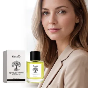 Detail view of Roxelis Pear Blossom Rain perfume oil bottle and textured white packaging.