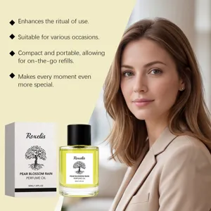Elegant woman with Roxelis Pear Blossom Rain perfume oil in a clear 50ml bottle
