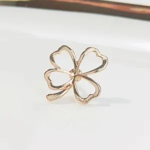 Detailed macro shot of an elegant rose gold four-leaf clover brooch pin with hollow design