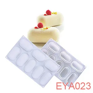 Detailed view of white silicone baking mold with delicious mousse cake and raspberry garnish.