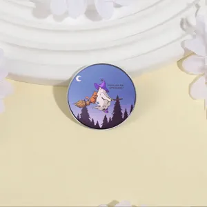 Round Halloween metal brooch featuring a ghost riding a broom and snacks text