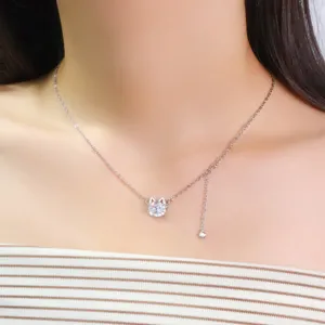 Primer plano de un elegante collar plateado con un colgante de gato de circonita brillante