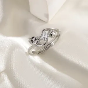 Silver dog-themed open ring with zircon stone and paw print on white silk background